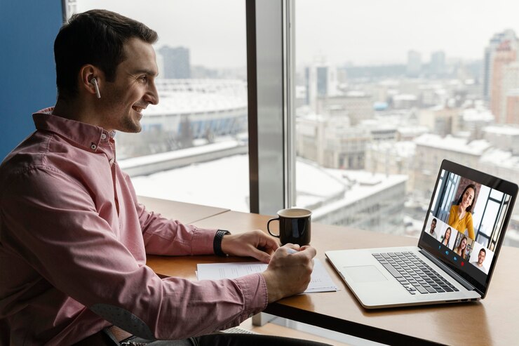 Remote employee smiling looking at laptop
